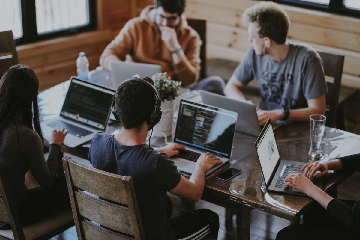 Team working in an office sat at desks