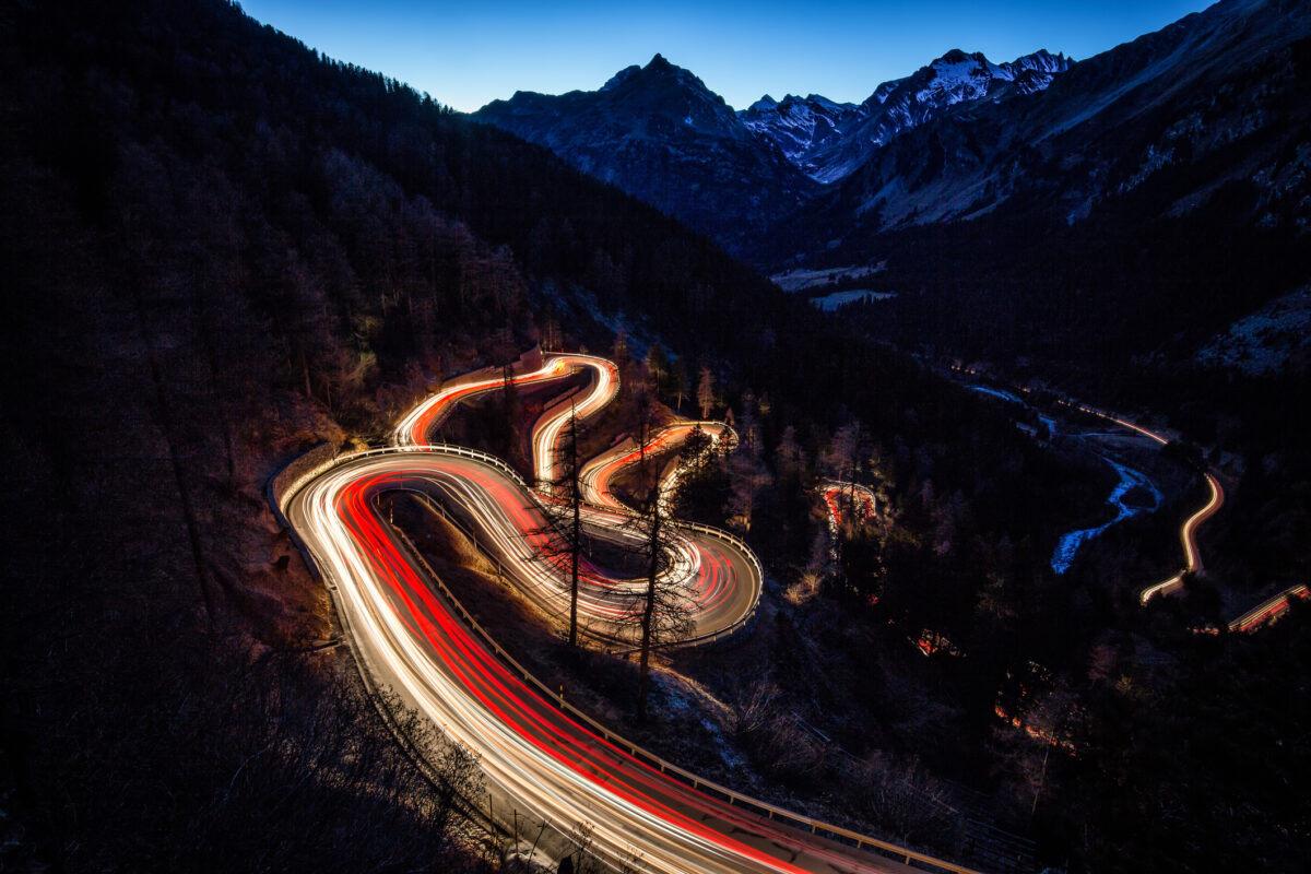 Mountain Pass Road Maloja curves at Night with traffic lights